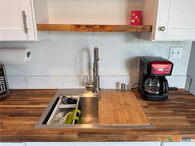 1008 W Dallas Ave, Seadrift, TX 77983 - room details with white cabinets and wooden counters