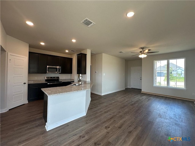 907 James Parker Cir, Killeen, TX 76542 - kitchen with stainless steel appliances, dark wood finished floors, open floor plan, a ceiling fan, and light stone counters