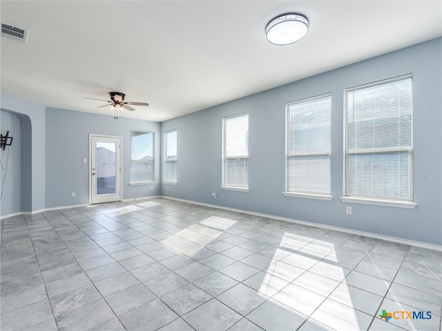 spare room featuring ceiling fan and light tile patterned floors