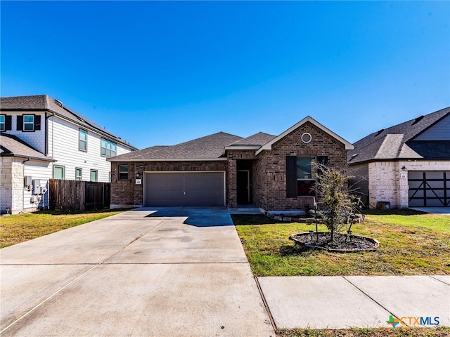 view of front of property featuring a garage and a front lawn