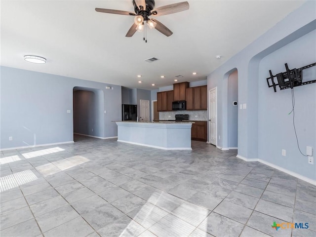 tiled spare room with ceiling fan and plenty of natural light