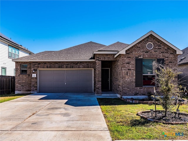 view of front of home with a garage and a front lawn