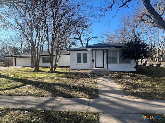 ranch-style home with a front yard and a garage