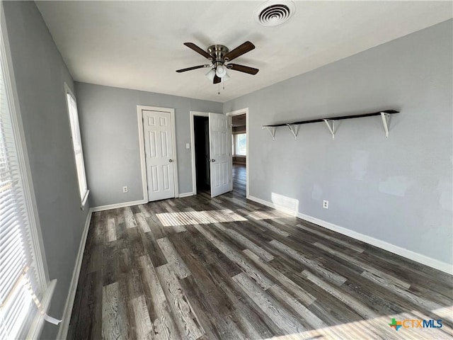 unfurnished bedroom with ceiling fan and dark hardwood / wood-style floors