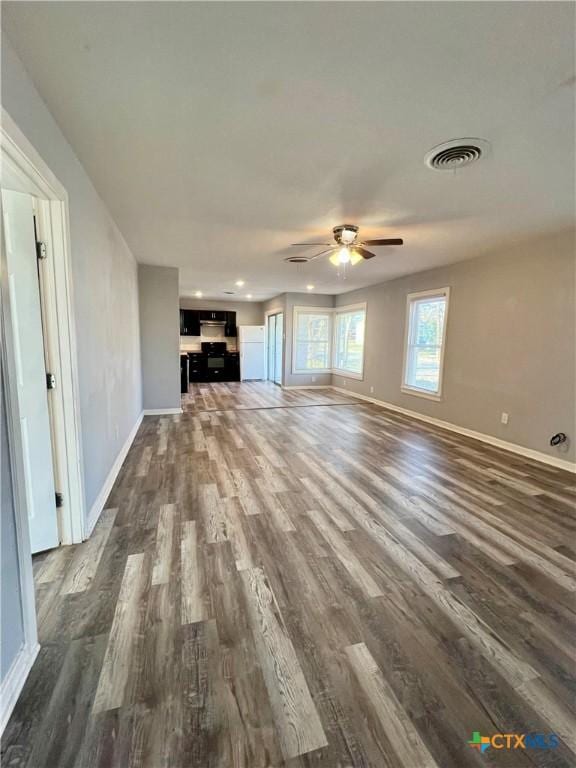 unfurnished living room with ceiling fan and dark hardwood / wood-style floors