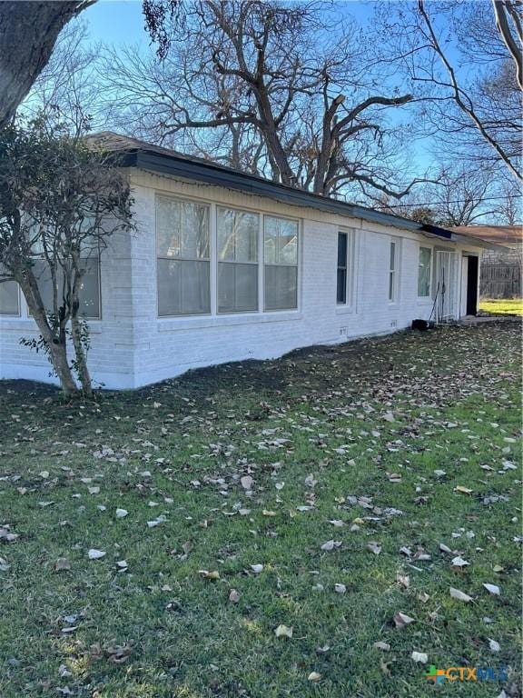 view of side of property featuring a yard