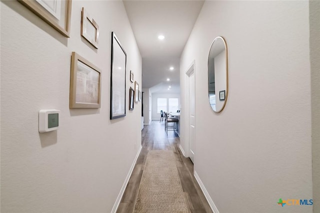 hallway with wood-type flooring