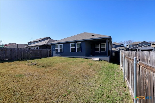 rear view of property with a lawn