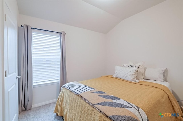 carpeted bedroom with vaulted ceiling