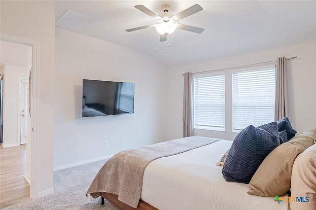 carpeted bedroom featuring ceiling fan and lofted ceiling