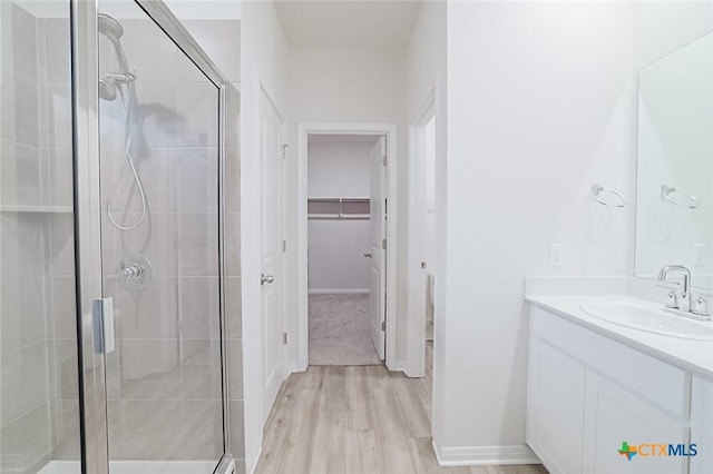 bathroom featuring vanity, hardwood / wood-style floors, and an enclosed shower