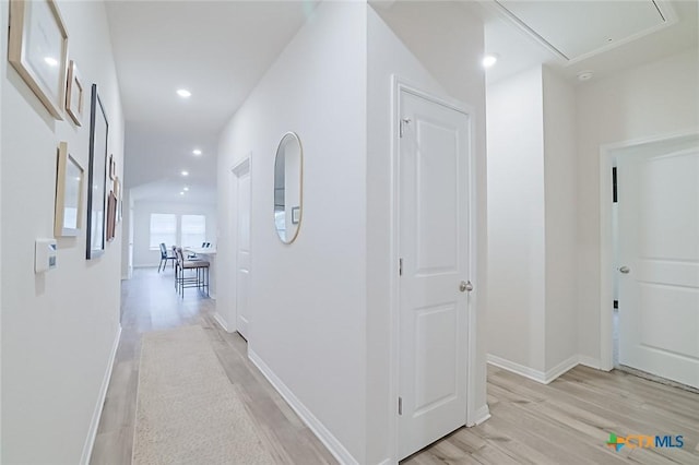 corridor with light hardwood / wood-style flooring