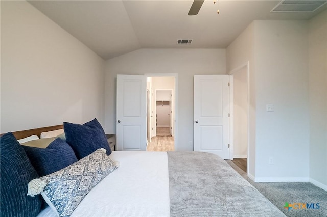 carpeted bedroom featuring ceiling fan and lofted ceiling