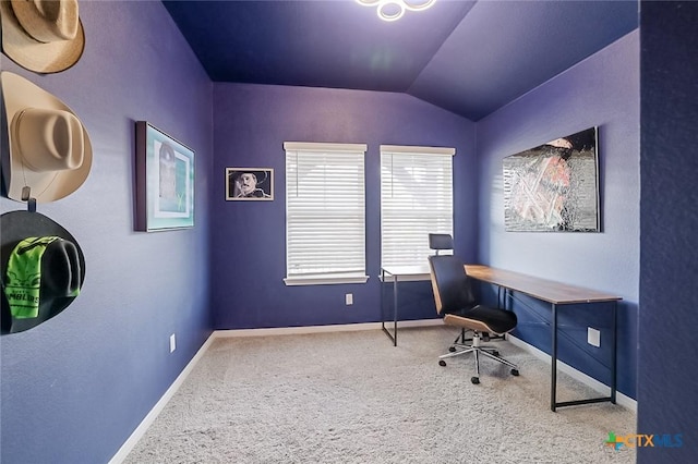 carpeted home office featuring vaulted ceiling