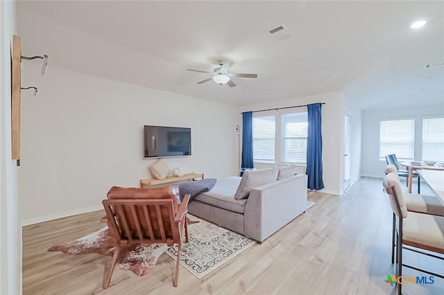 living room featuring ceiling fan and light wood-type flooring