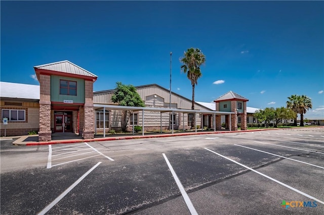 view of building exterior featuring uncovered parking