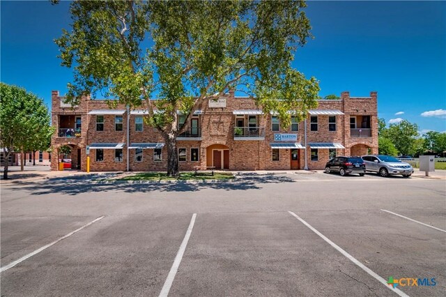 view of property with uncovered parking