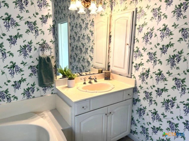 2772 Cloisters Dr, College Station, TX 77845 - full bathroom with wallpapered walls, vanity, a chandelier, and a bath