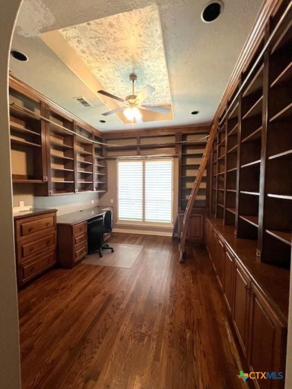 2772 Cloisters Dr, College Station, TX 77845 - unfurnished office featuring a raised ceiling, a ceiling fan, a textured ceiling, dark wood finished floors, and built in desk