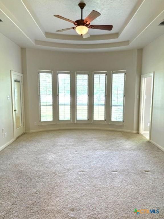 2772 Cloisters Dr, College Station, TX 77845 - carpeted spare room with a raised ceiling, plenty of natural light, and a ceiling fan