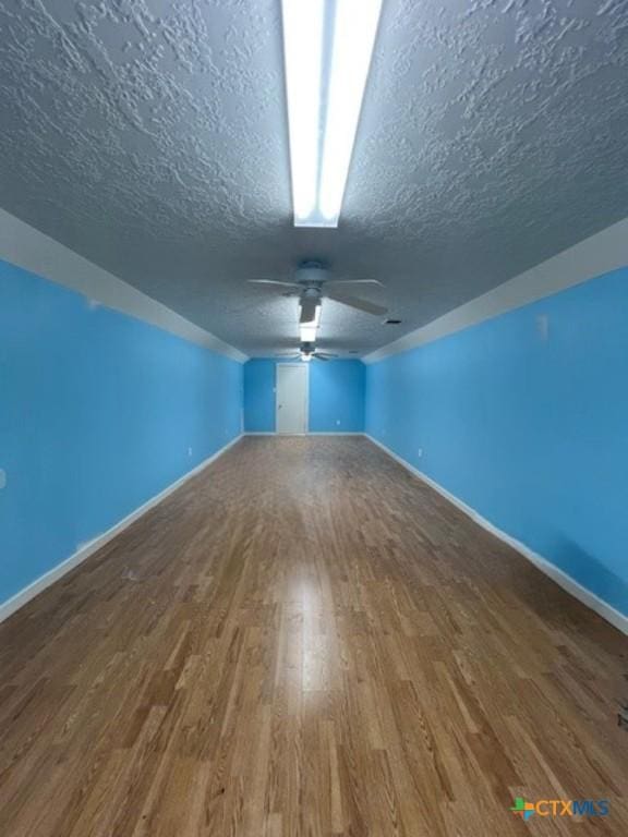 2772 Cloisters Dr, College Station, TX 77845 - bonus room featuring a textured ceiling, wood finished floors, and ceiling fan