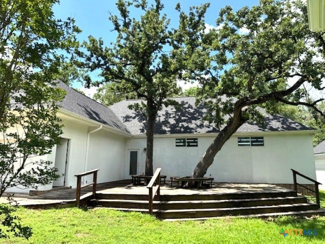 2772 Cloisters Dr, College Station, TX 77845 - rear view of house with a wooden deck, a yard, stucco siding, and roof with shingles