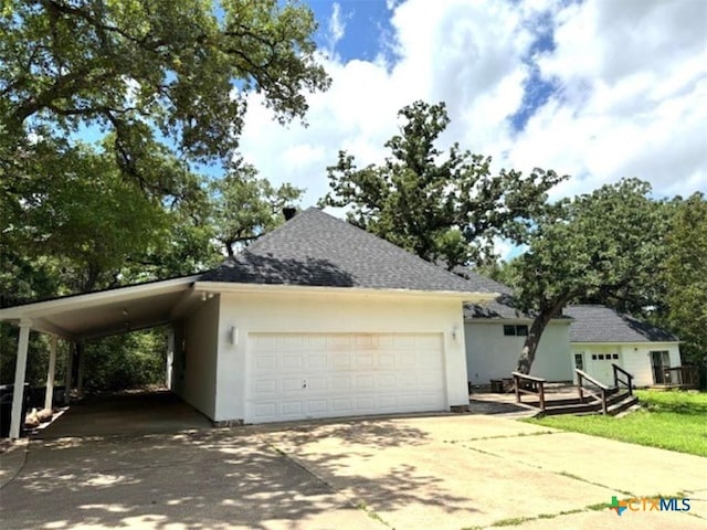 2772 Cloisters Dr, College Station, TX 77845 - view of front of home with driveway, a shingled roof, stucco siding, and a garage
