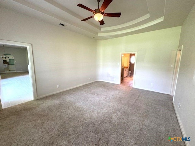 2772 Cloisters Dr, College Station, TX 77845 - carpeted spare room featuring a ceiling fan and a tray ceiling