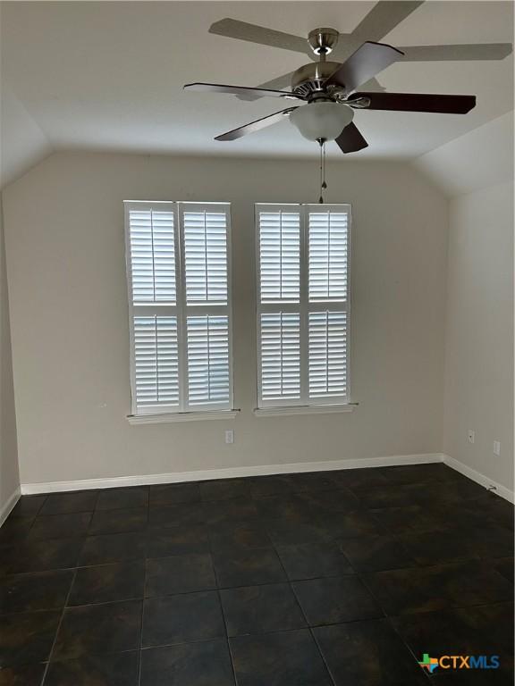 spare room with ceiling fan, lofted ceiling, and plenty of natural light