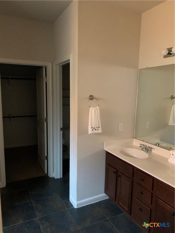 bathroom with vanity, tile patterned floors, and toilet