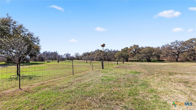 view of yard featuring a rural view and fence