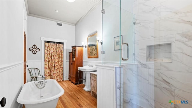 full bath with a wainscoted wall, visible vents, ornamental molding, a shower stall, and vanity