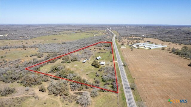 birds eye view of property with a rural view