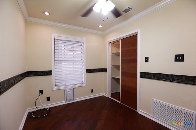 spare room featuring visible vents, a ceiling fan, crown molding, and wood finished floors
