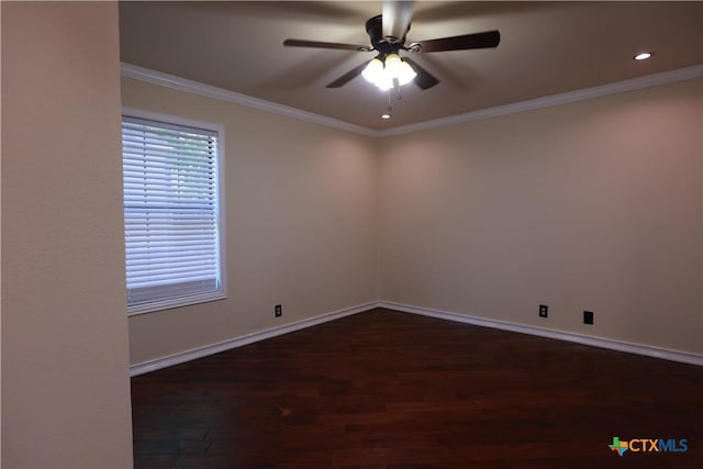 spare room with a ceiling fan, baseboards, dark wood finished floors, and ornamental molding