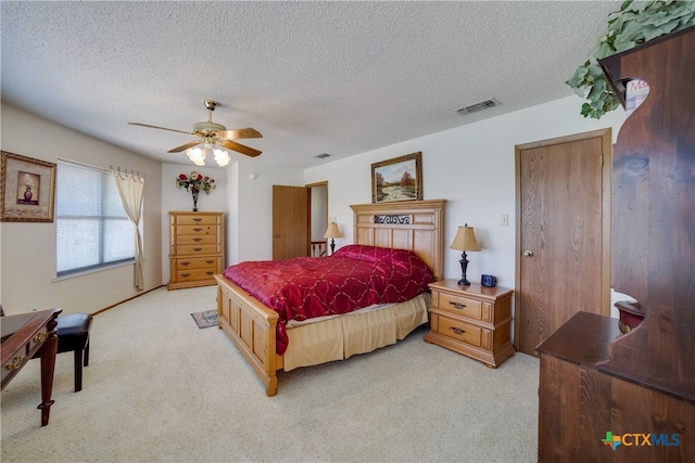 323 E Klein Rd, New Braunfels, TX 78130 - carpeted bedroom with a textured ceiling and ceiling fan