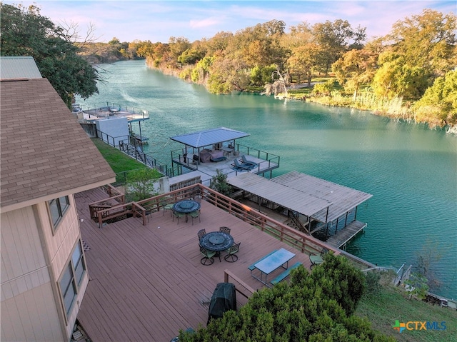 view of dock with a deck with water view