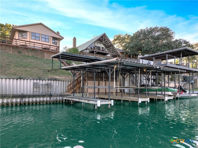 exterior space with a water view and a dock