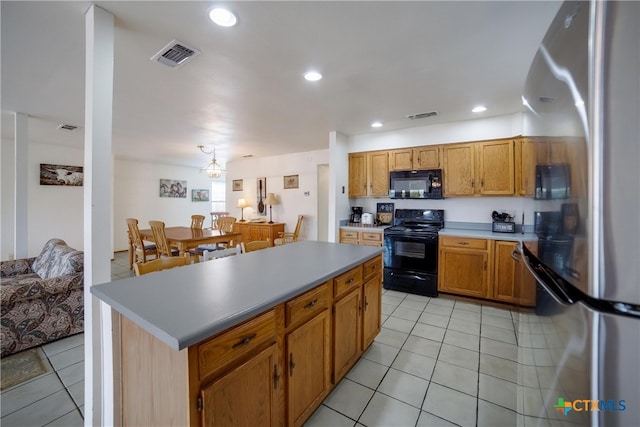 323 E Klein Rd, New Braunfels, TX 78130 - kitchen featuring black appliances, a kitchen island, and light tile patterned floors