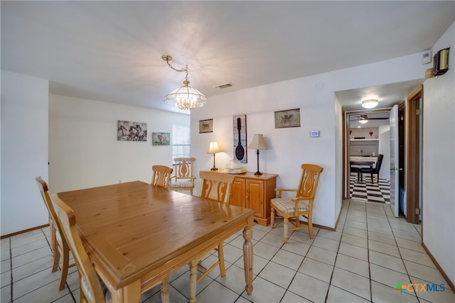 323 E Klein Rd, New Braunfels, TX 78130 - dining space with light tile patterned floors and ceiling fan with notable chandelier