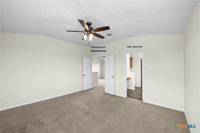 unfurnished bedroom featuring baseboards, visible vents, carpet floors, and lofted ceiling