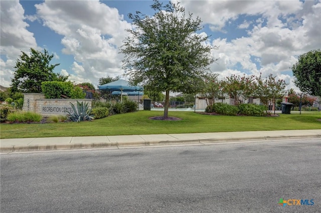 exterior space featuring a front yard and fence