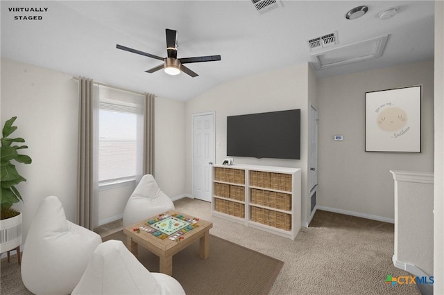 living area featuring vaulted ceiling, a ceiling fan, visible vents, and carpet floors