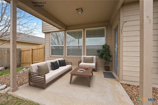 view of patio featuring fence and an outdoor hangout area