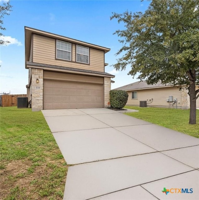 traditional home featuring a front yard, concrete driveway, central AC unit, and stone siding