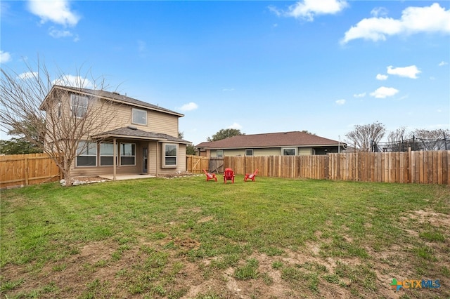 back of property featuring a patio, a lawn, and a fenced backyard