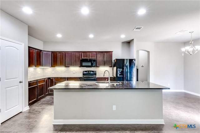 1202 Jester Ct, Copperas Cove, TX 76522 - kitchen featuring black appliances, arched walkways, decorative backsplash, an island with sink, and recessed lighting