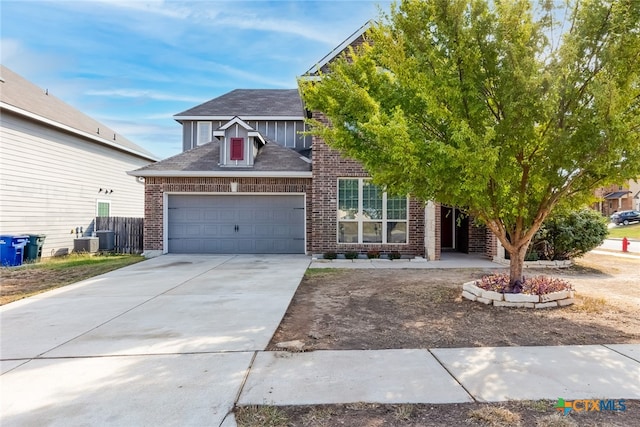 view of front of property featuring a garage and cooling unit