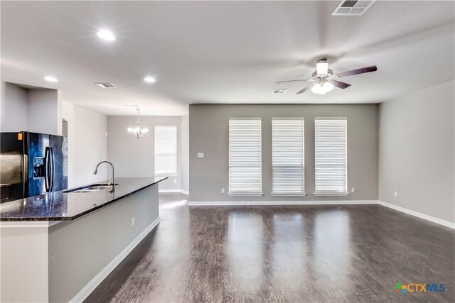 1202 Jester Ct, Copperas Cove, TX 76522 - kitchen featuring black fridge, ceiling fan, a chandelier, a kitchen island with sink, and dark wood finished floors