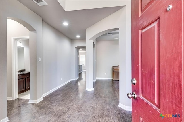 1202 Jester Ct, Copperas Cove, TX 76522 - entrance foyer with dark wood-style flooring, arched walkways, and recessed lighting